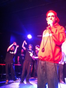 Ridjanovic as "Robert Nelson" in foreground while winners celebrate their cash.