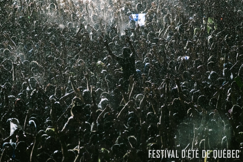 Crowd in a violent thunderstorm at the Foo Fighters gig - Festival d'Été de Québec 2015 . Photo credit: Renaud Philippe.